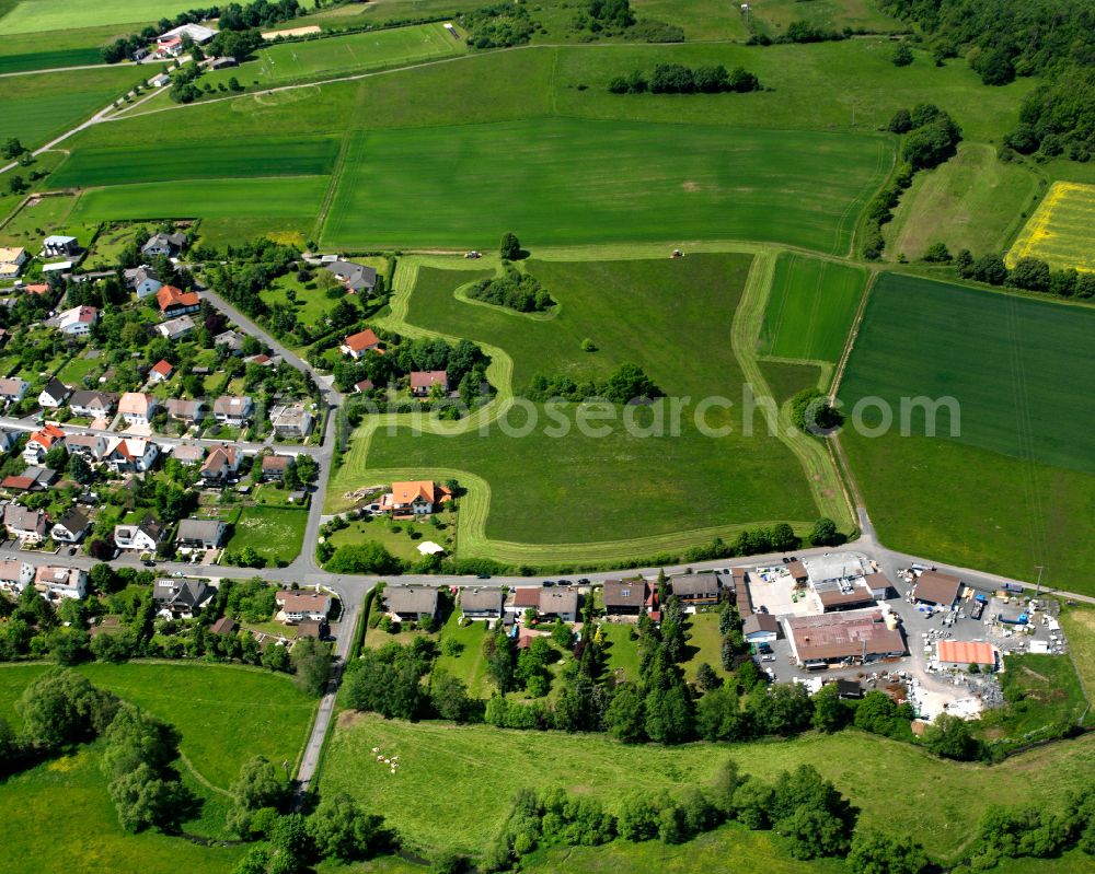 Frischborn from the bird's eye view: Village view on the edge of agricultural fields and land in Frischborn in the state Hesse, Germany