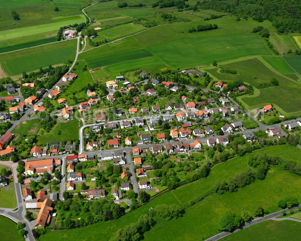 Aerial image Frischborn - Village view on the edge of agricultural fields and land in Frischborn in the state Hesse, Germany