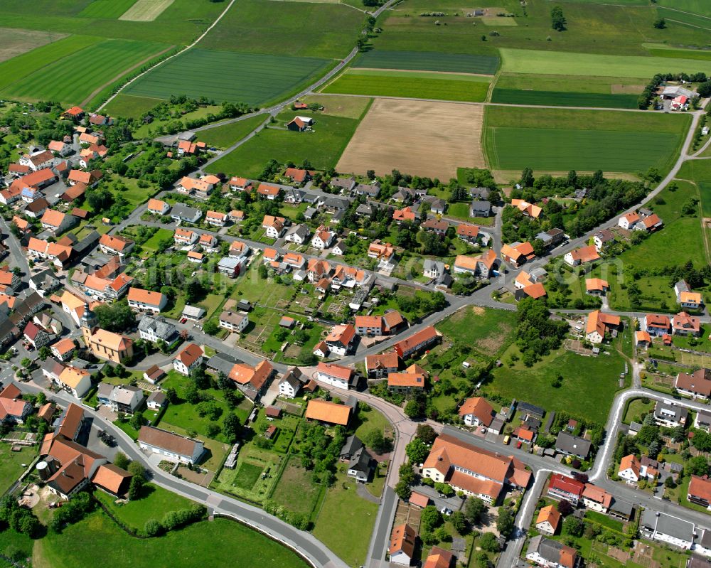 Aerial photograph Frischborn - Village view on the edge of agricultural fields and land in Frischborn in the state Hesse, Germany