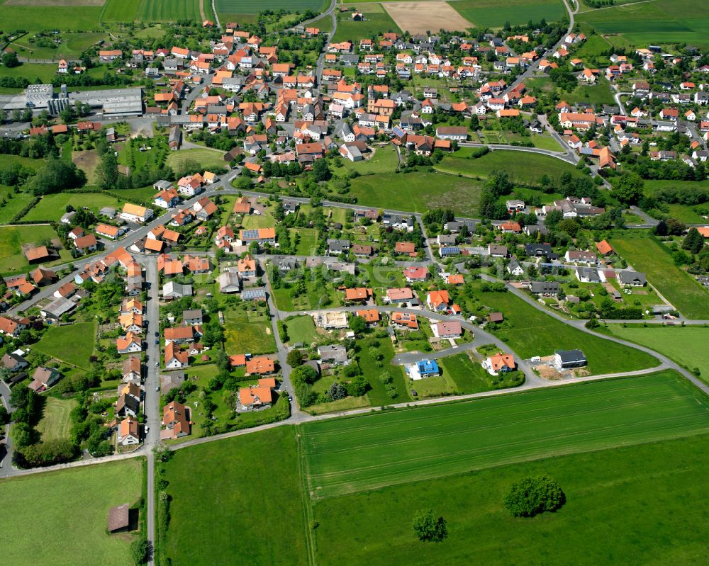 Frischborn from the bird's eye view: Village view on the edge of agricultural fields and land in Frischborn in the state Hesse, Germany