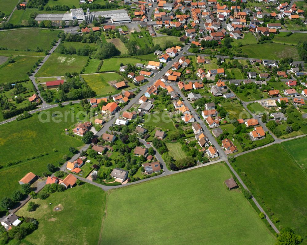 Aerial image Frischborn - Village view on the edge of agricultural fields and land in Frischborn in the state Hesse, Germany