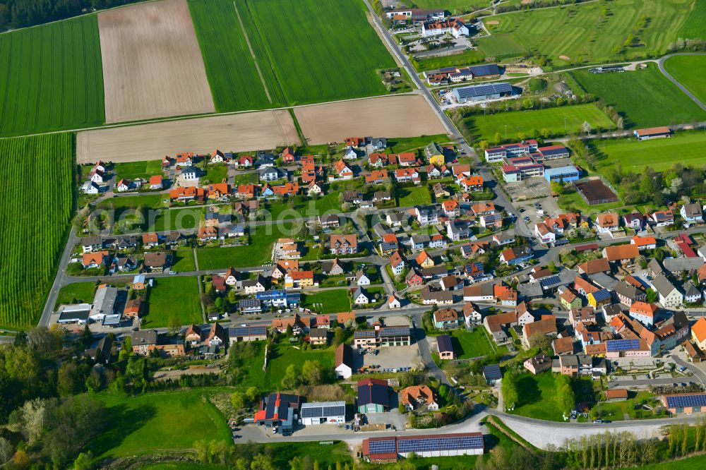 Aerial image Geiselwind - Village view on the edge of agricultural fields and land in Geiselwind in the state Bavaria, Germany