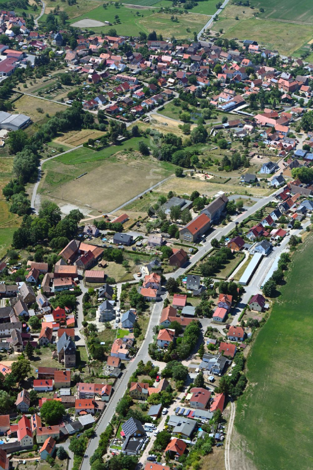 Golmsdorf from the bird's eye view: Village view on the edge of agricultural fields and land in Golmsdorf in the state Thuringia, Germany