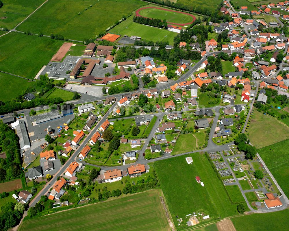 Grebenhain from above - Village view on the edge of agricultural fields and land in Grebenhain in the state Hesse, Germany