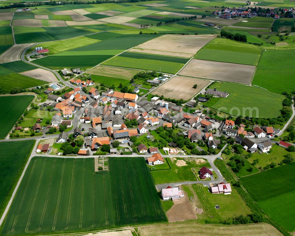 Aerial image Haarhausen - Village view on the edge of agricultural fields and land in Haarhausen in the state Hesse, Germany