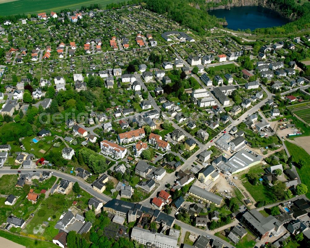 Hartmannsdorf from the bird's eye view: Village view on the edge of agricultural fields and land in Hartmannsdorf in the state Saxony, Germany