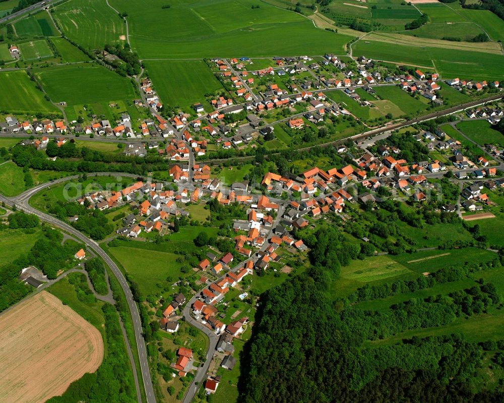 Hönebach from above - Village view on the edge of agricultural fields and land in Hönebach in the state Hesse, Germany