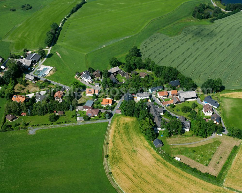 Aerial image Hof - Village view on the edge of agricultural fields and land in Hof in the state Bavaria, Germany