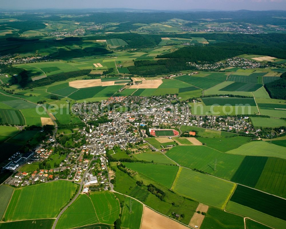 Kirberg from the bird's eye view: Village view on the edge of agricultural fields and land in Kirberg in the state Hesse, Germany