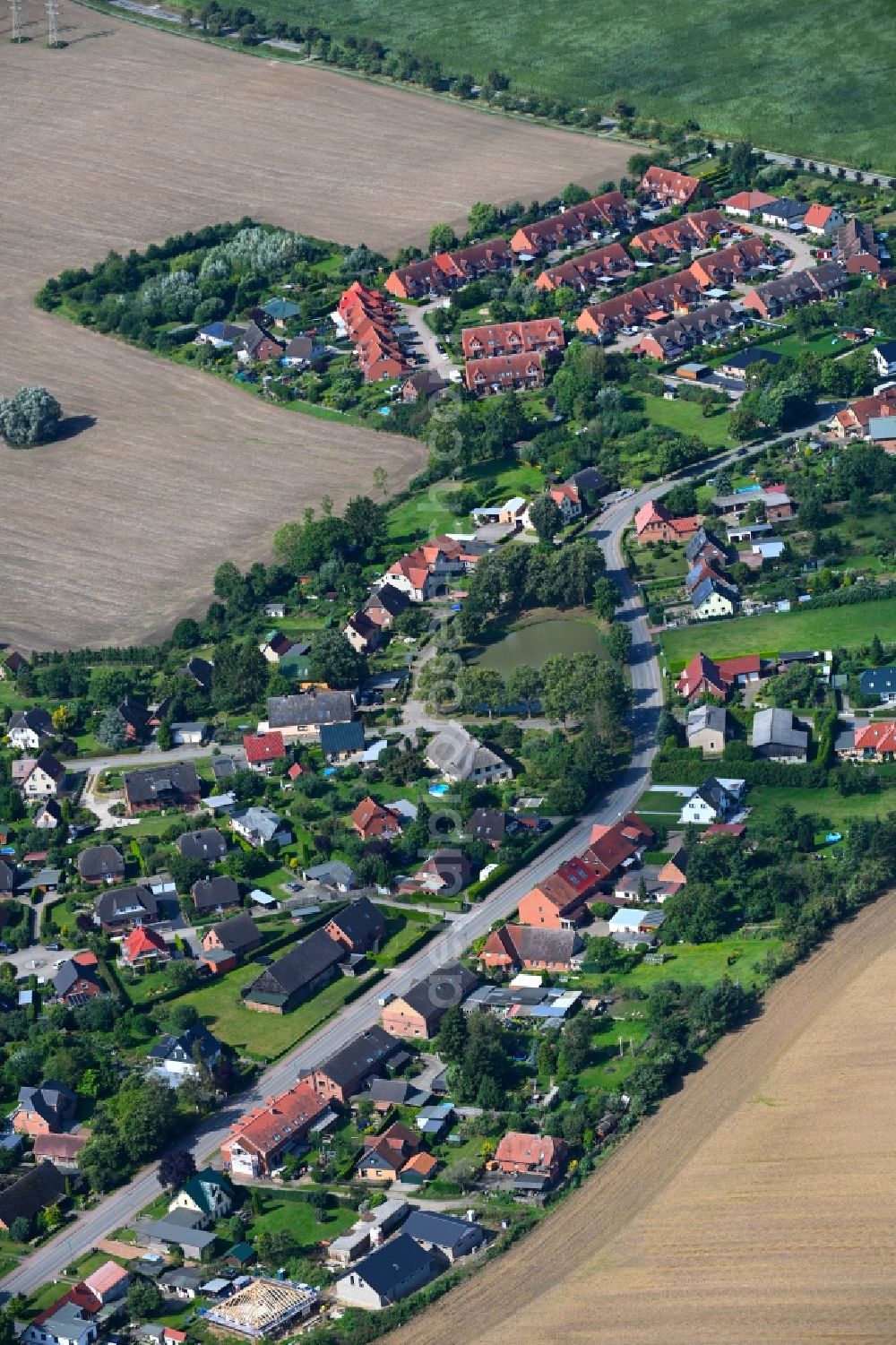 Klein Rogahn from the bird's eye view: Village view on the edge of agricultural fields and land in Klein Rogahn in the state Mecklenburg - Western Pomerania, Germany