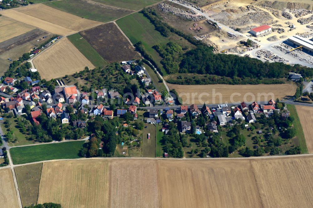 Kleinrinderfeld from the bird's eye view: Village view on the edge of agricultural fields and land in Kleinrinderfeld in the state Bavaria, Germany