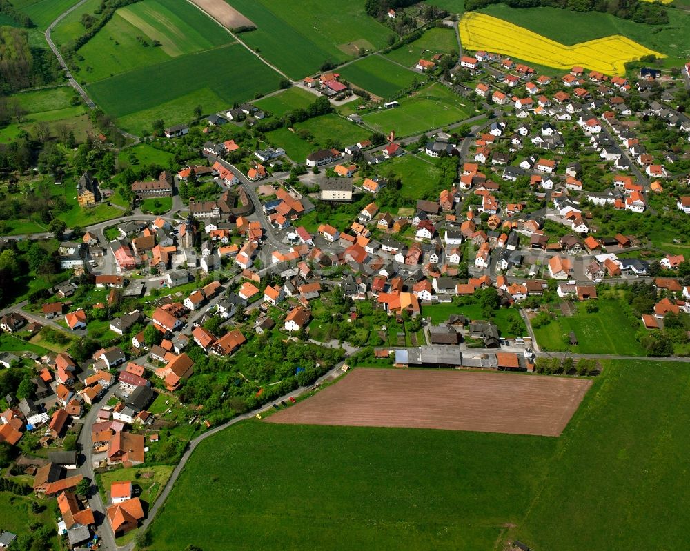 Mansbach from the bird's eye view: Village view on the edge of agricultural fields and land in Mansbach in the state Hesse, Germany