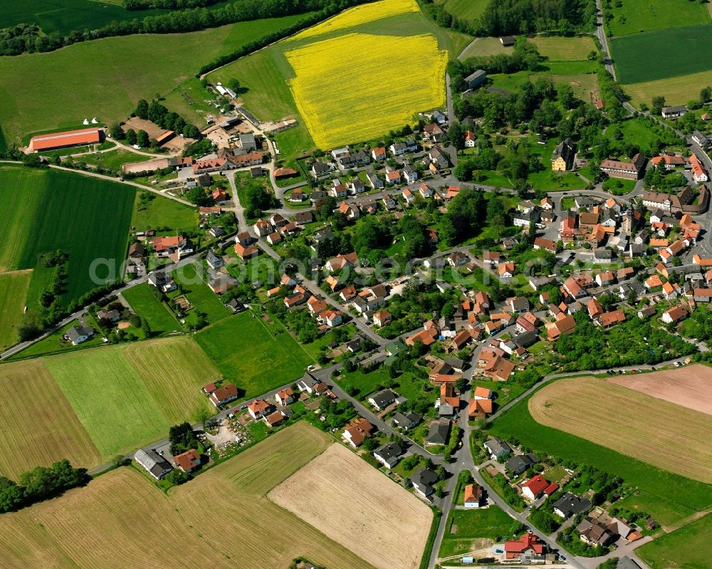 Mansbach from the bird's eye view: Village view on the edge of agricultural fields and land in Mansbach in the state Hesse, Germany