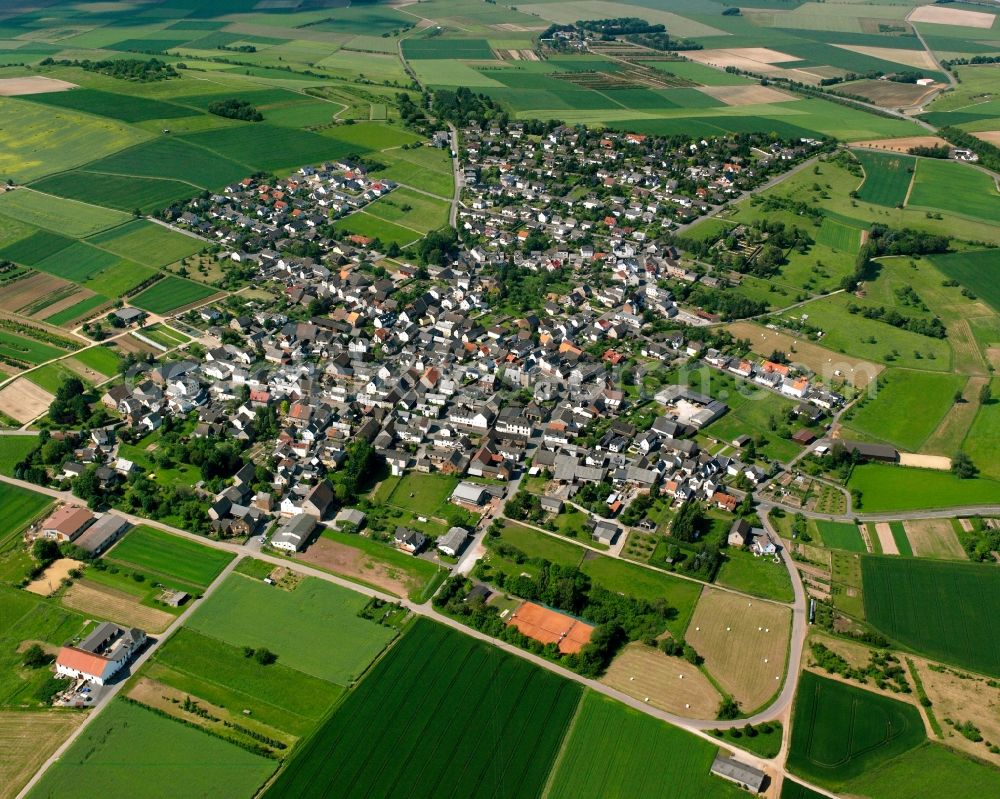 Mensfelden from the bird's eye view: Village view on the edge of agricultural fields and land in Mensfelden in the state Hesse, Germany