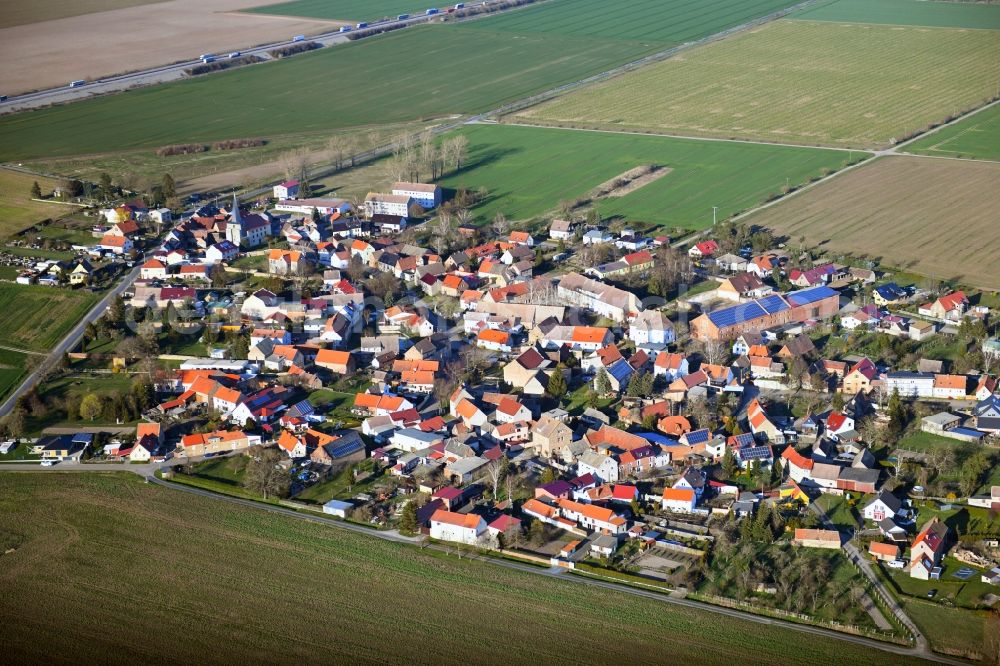 Mittelhausen from the bird's eye view: Village view on the edge of agricultural fields and land in Mittelhausen in the state Saxony-Anhalt, Germany