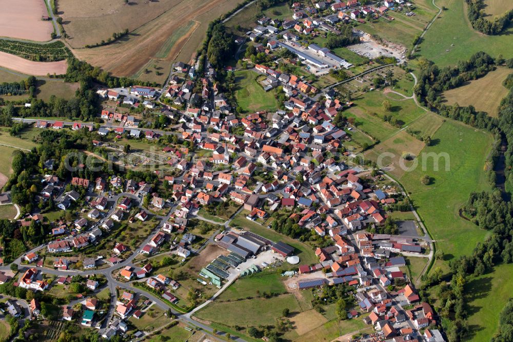 Mittelsinn from above - Village view on the edge of agricultural fields and land in Mittelsinn in the state Bavaria, Germany