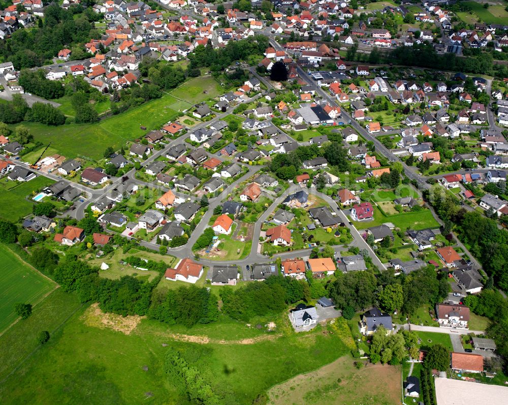 Nieder-Ohmen from the bird's eye view: Village view on the edge of agricultural fields and land in Nieder-Ohmen in the state Hesse, Germany