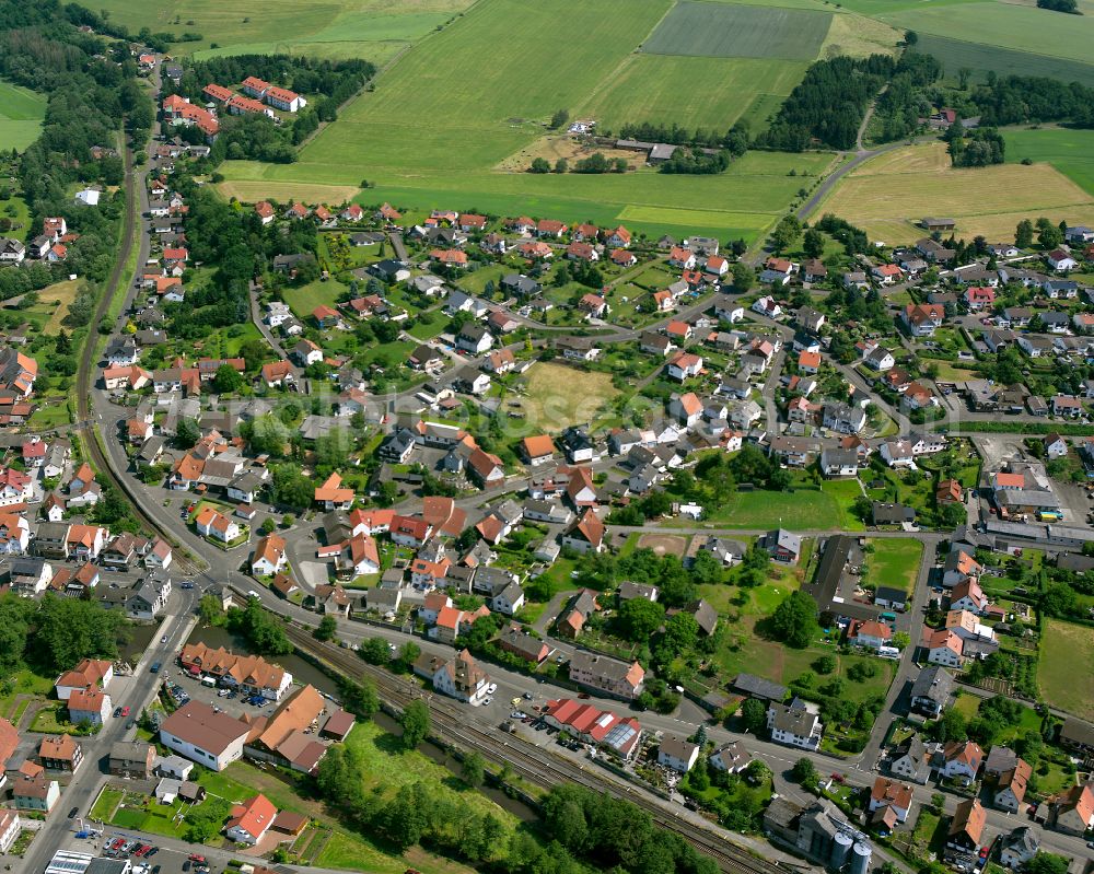 Aerial photograph Nieder-Ohmen - Village view on the edge of agricultural fields and land in Nieder-Ohmen in the state Hesse, Germany