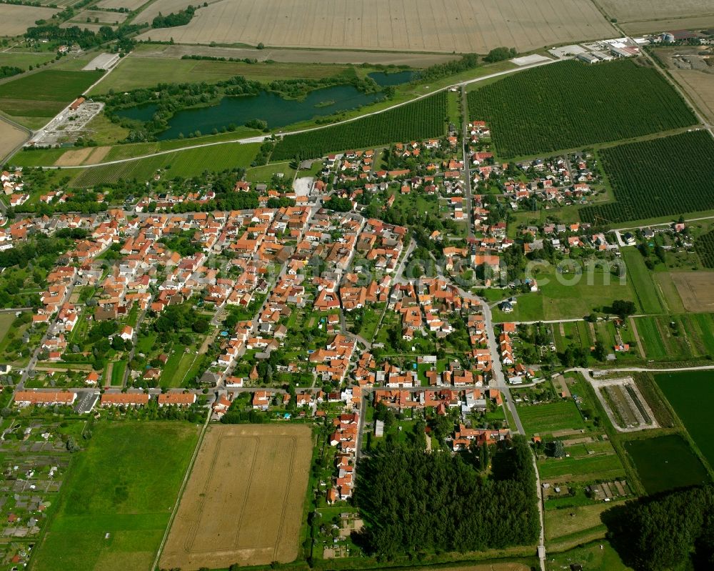 Niederdorla from the bird's eye view: Village view on the edge of agricultural fields and land in Niederdorla in the state Thuringia, Germany