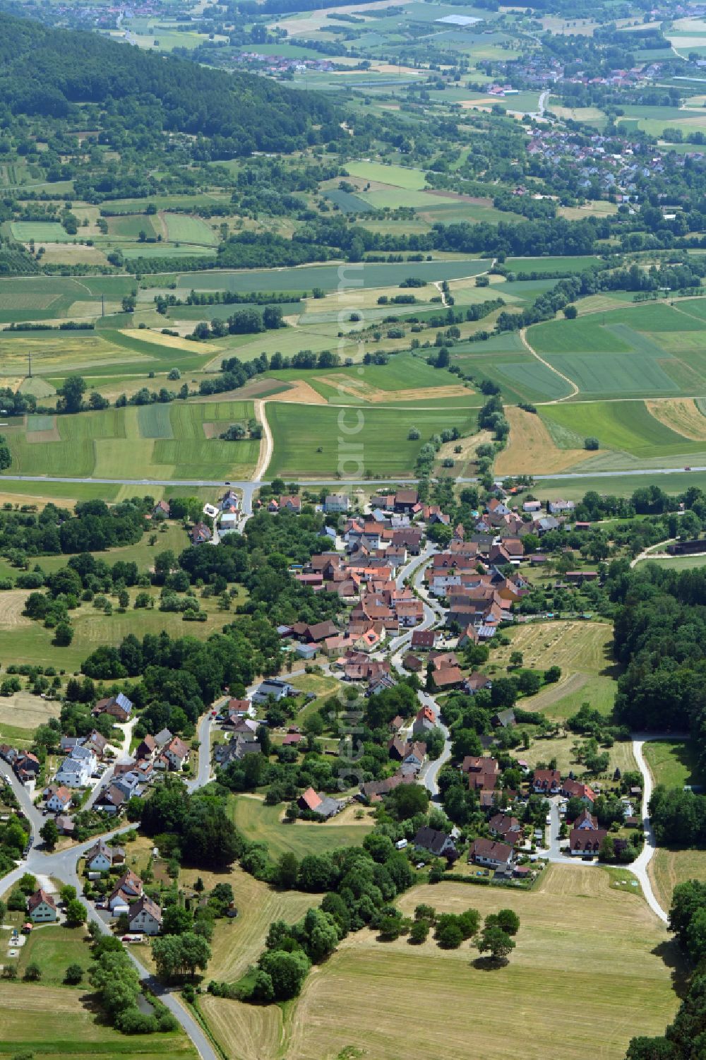 Aerial image Niedermirsberg - Village view on the edge of agricultural fields and land in Niedermirsberg in the state Bavaria, Germany