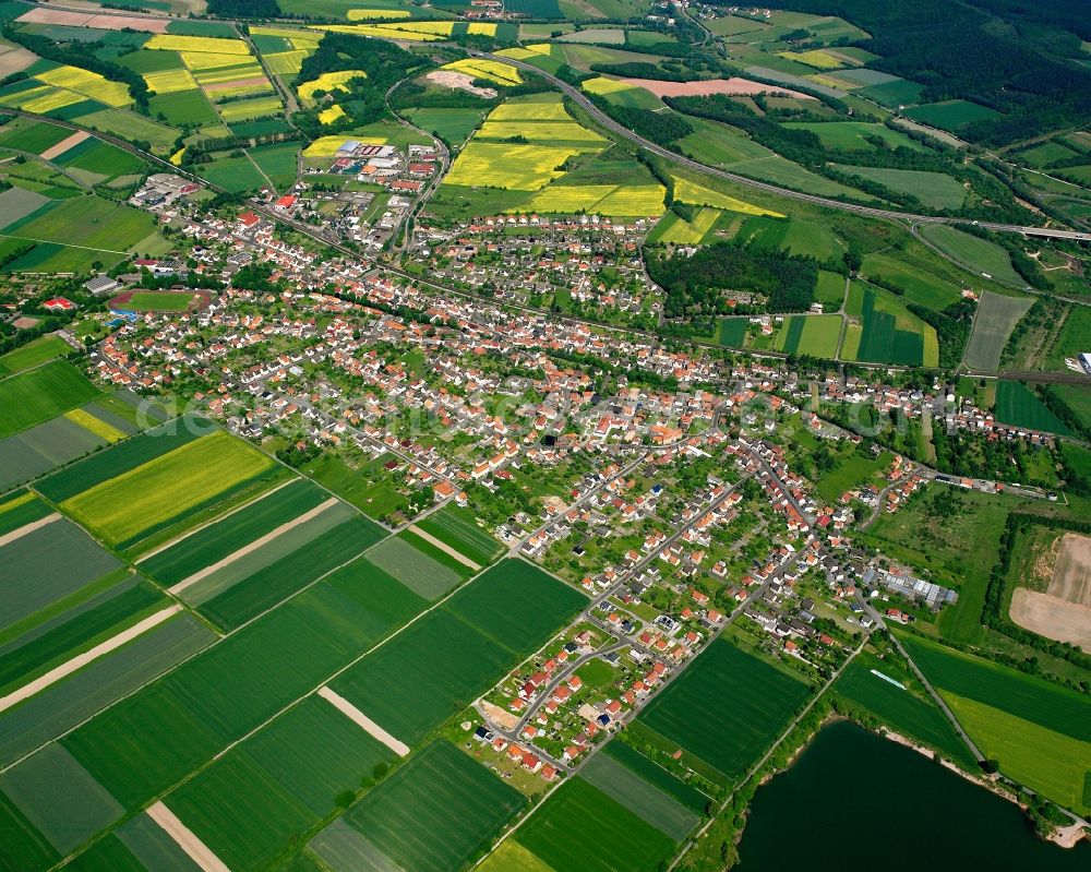 Obersuhl from above - Village view on the edge of agricultural fields and land in Obersuhl in the state Hesse, Germany