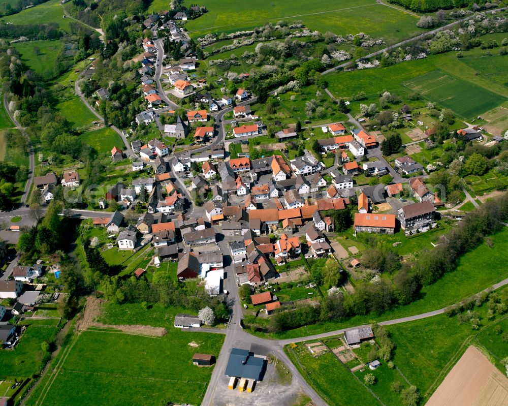 Aerial image Odenhausen - Village view on the edge of agricultural fields and land in Odenhausen in the state Hesse, Germany