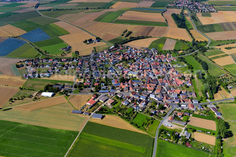 Prosselsheim from the bird's eye view: Village view on the edge of agricultural fields and land in Prosselsheim in the state Bavaria, Germany