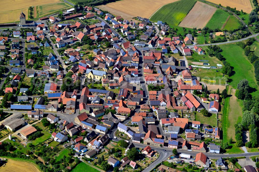 Püssensheim from above - Village view on the edge of agricultural fields and land in Püssensheim in the state Bavaria, Germany