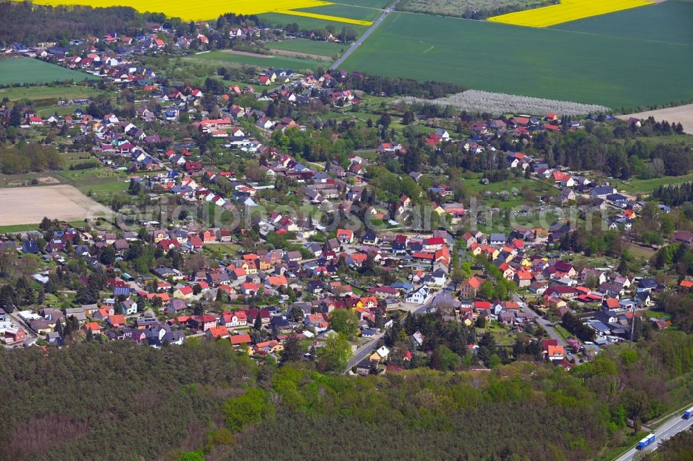 Rauen from the bird's eye view: Village view on the edge of agricultural fields and land in Rauen in the state Brandenburg, Germany