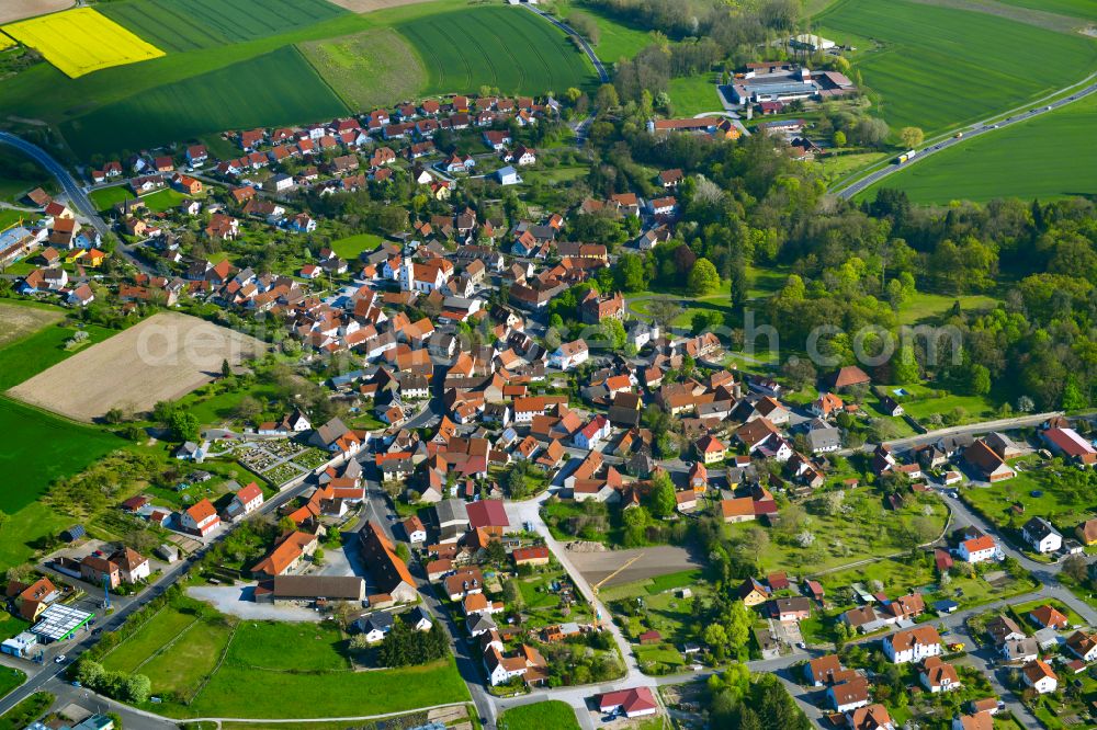 Rüdenhausen from the bird's eye view: Village view on the edge of agricultural fields and land in Rüdenhausen in the state Bavaria, Germany