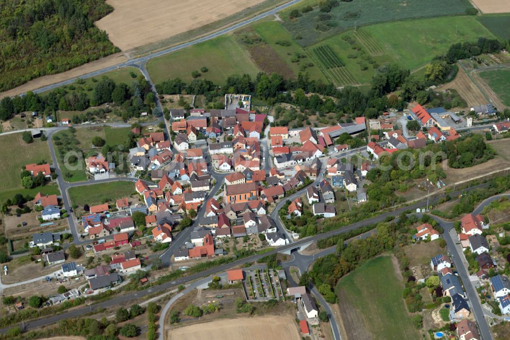 Reuchelheim from the bird's eye view: Village view on the edge of agricultural fields and land in Reuchelheim in the state Bavaria, Germany