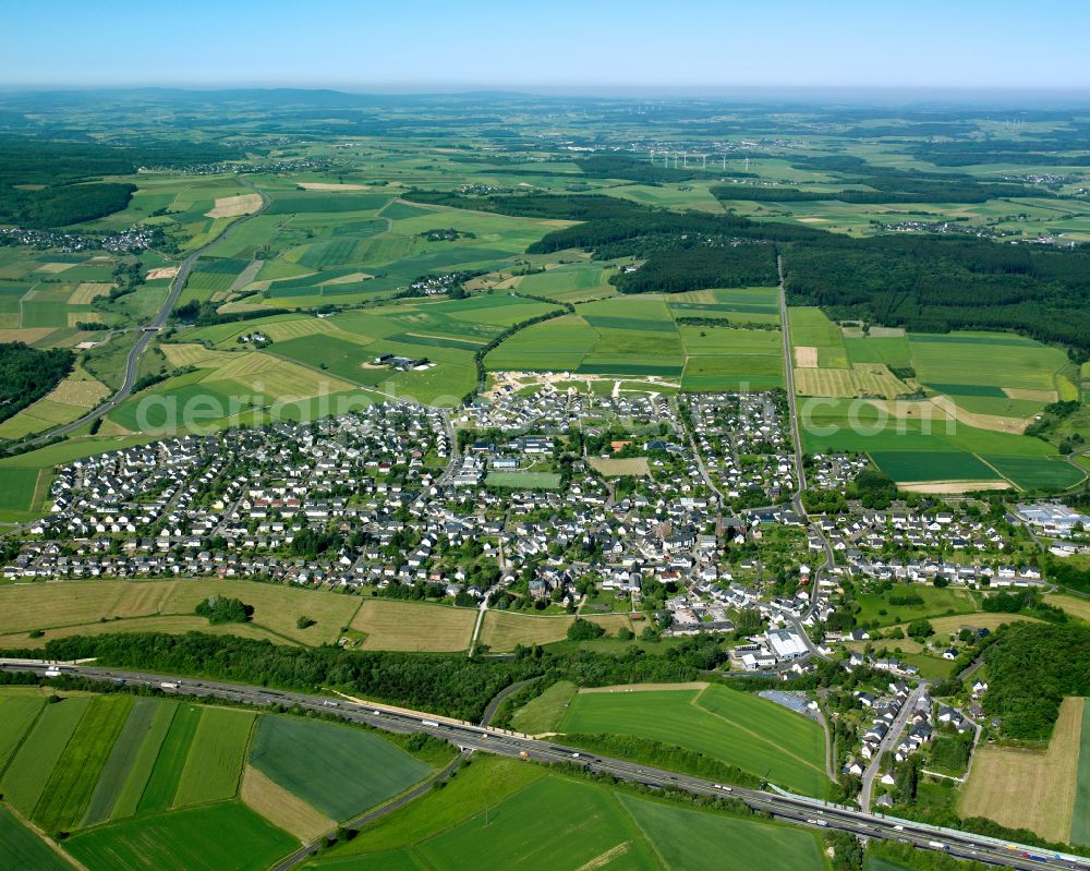 Rheinböllen from above - Village view on the edge of agricultural fields and land in Rheinböllen in the state Rhineland-Palatinate, Germany