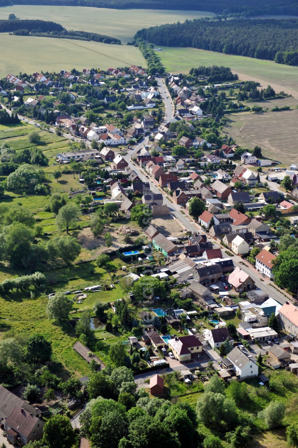 Schköna from above - Village view on the edge of agricultural fields and land on street Hauptstrasse in Schkoena in the state Saxony-Anhalt, Germany