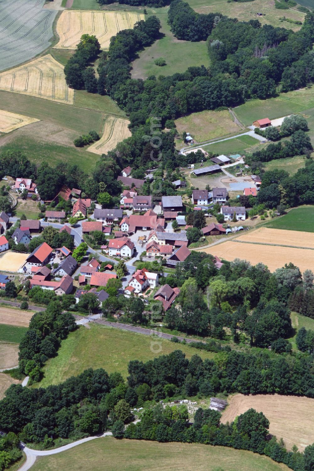 Aerial image Schlömen - Village view on the edge of agricultural fields and land in Schloemen in the state Bavaria, Germany