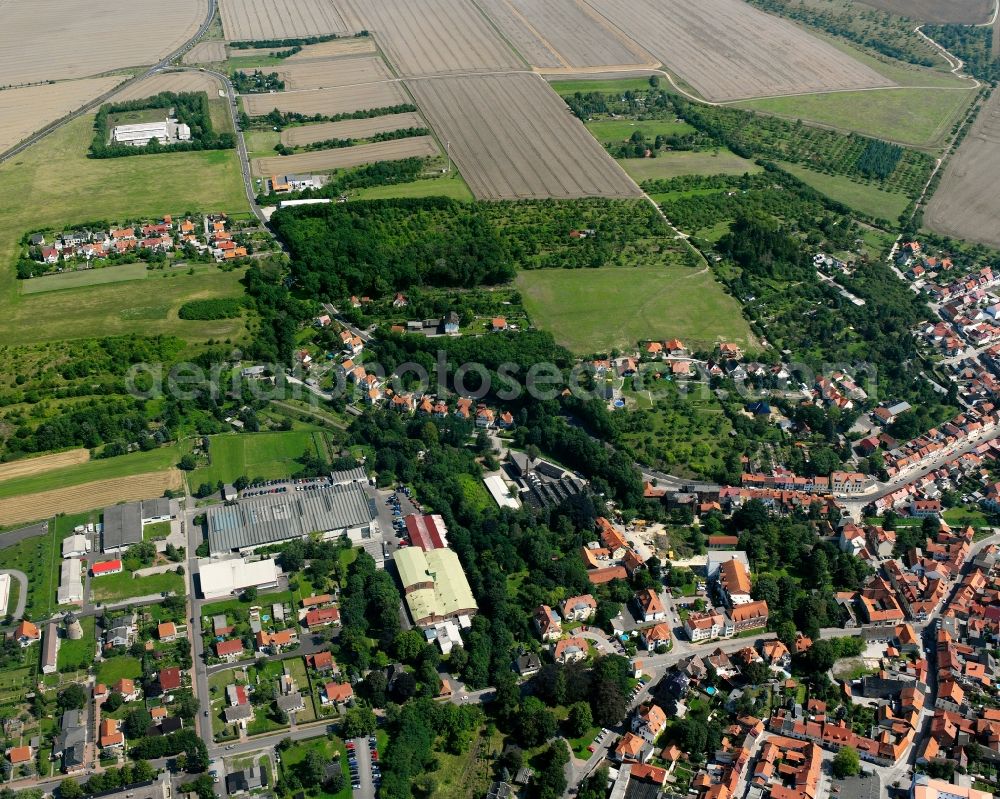 Schlotheim from the bird's eye view: Village view on the edge of agricultural fields and land in Schlotheim in the state Thuringia, Germany