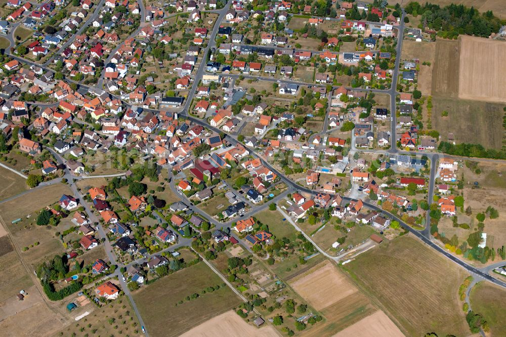 Schollbrunn from the bird's eye view: Village view on the edge of agricultural fields and land in Schollbrunn in the state Bavaria, Germany