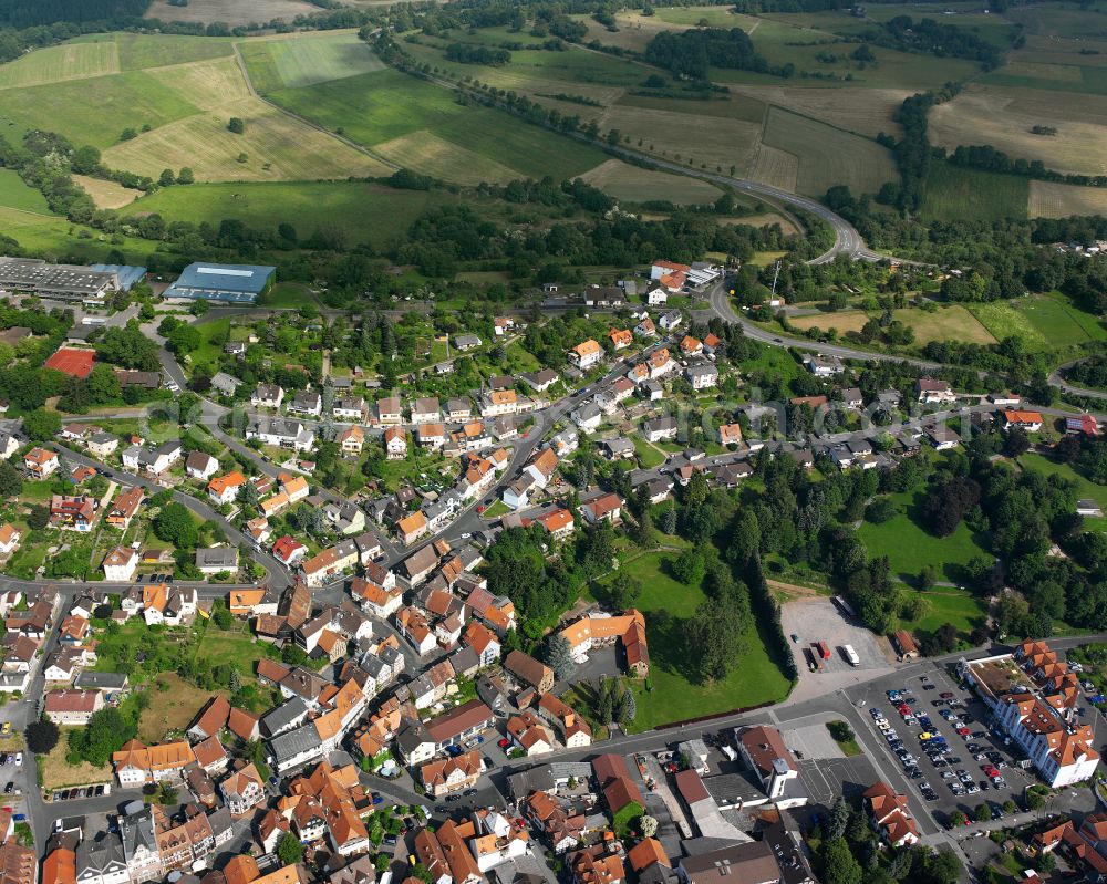 Schotten from the bird's eye view: Village view on the edge of agricultural fields and land in Schotten in the state Hesse, Germany