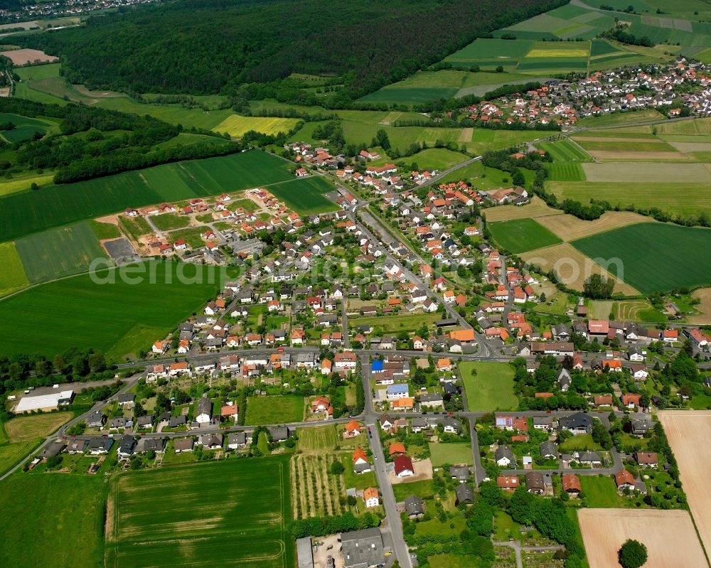 Sorga from the bird's eye view: Village view on the edge of agricultural fields and land in Sorga in the state Hesse, Germany