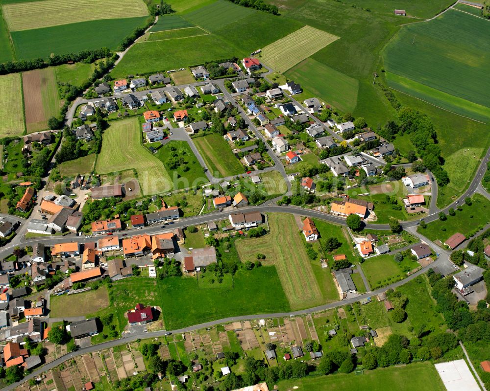 Storndorf from the bird's eye view: Village view on the edge of agricultural fields and land in Storndorf in the state Hesse, Germany