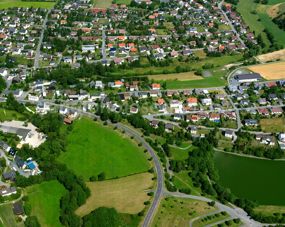 Aerial image Tauperlitz - Village view on the edge of agricultural fields and land in Tauperlitz in the state Bavaria, Germany