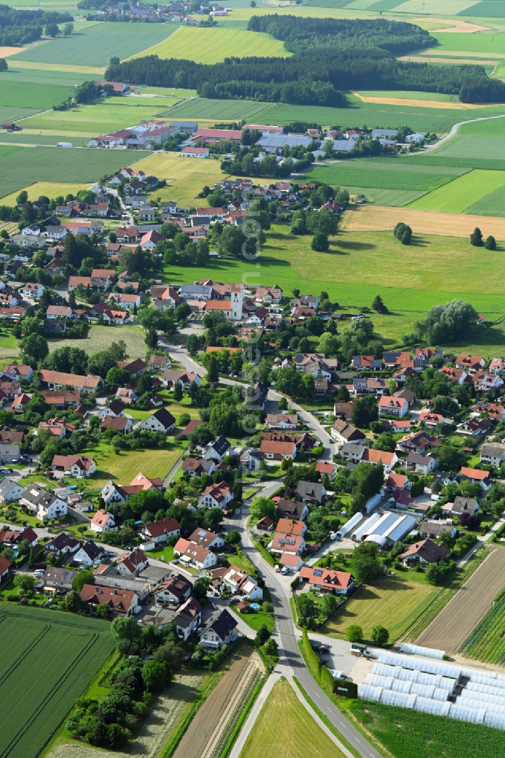 Aerial image Unterschweinbach - Village view on the edge of agricultural fields and land on street Hauptstrasse in Unterschweinbach in the state Bavaria, Germany