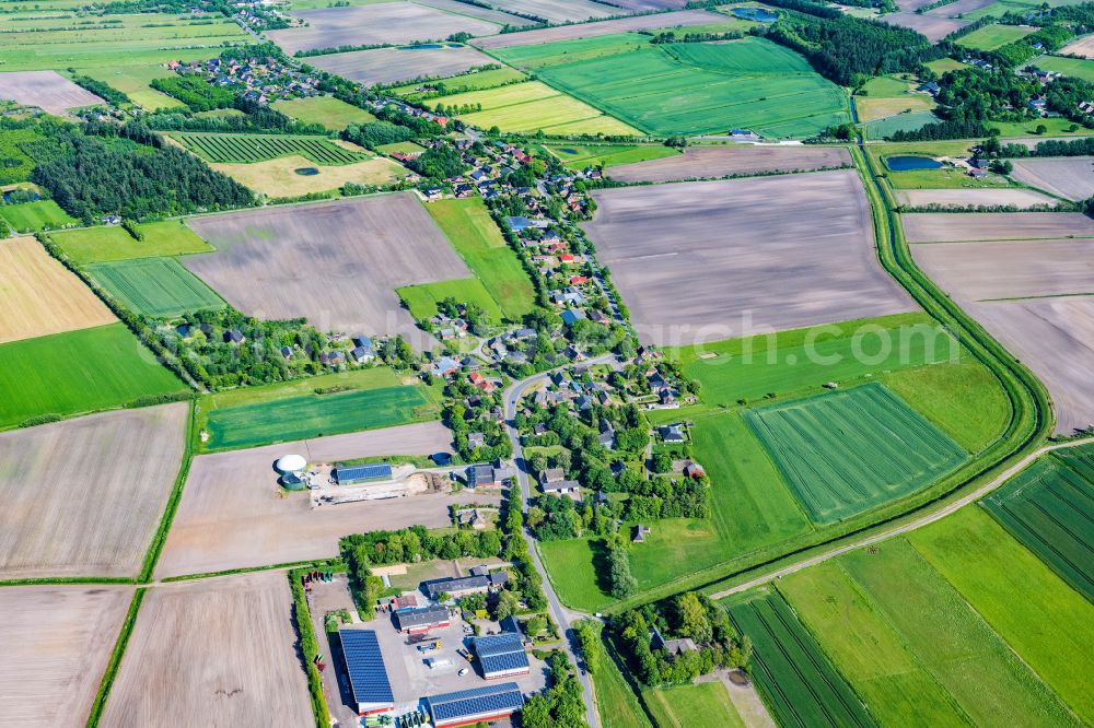 Uphusum from the bird's eye view: Village view on the edge of agricultural fields and land in Uphusum in the state Schleswig-Holstein, Germany