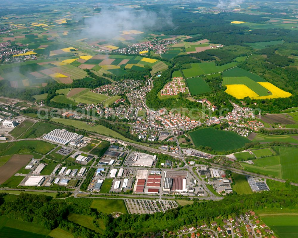 Aerial image Warthausen - View of the town on the edge of agricultural fields and land with adjoining commercial and industrial area in Warthausen in the state Baden-Wuerttemberg, Germany