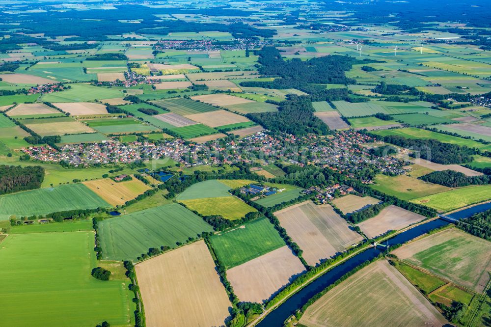 Wasbüttel from above - Village view on the edge of agricultural fields and land on street Am Koeweken in Wasbuettel in the state Lower Saxony, Germany