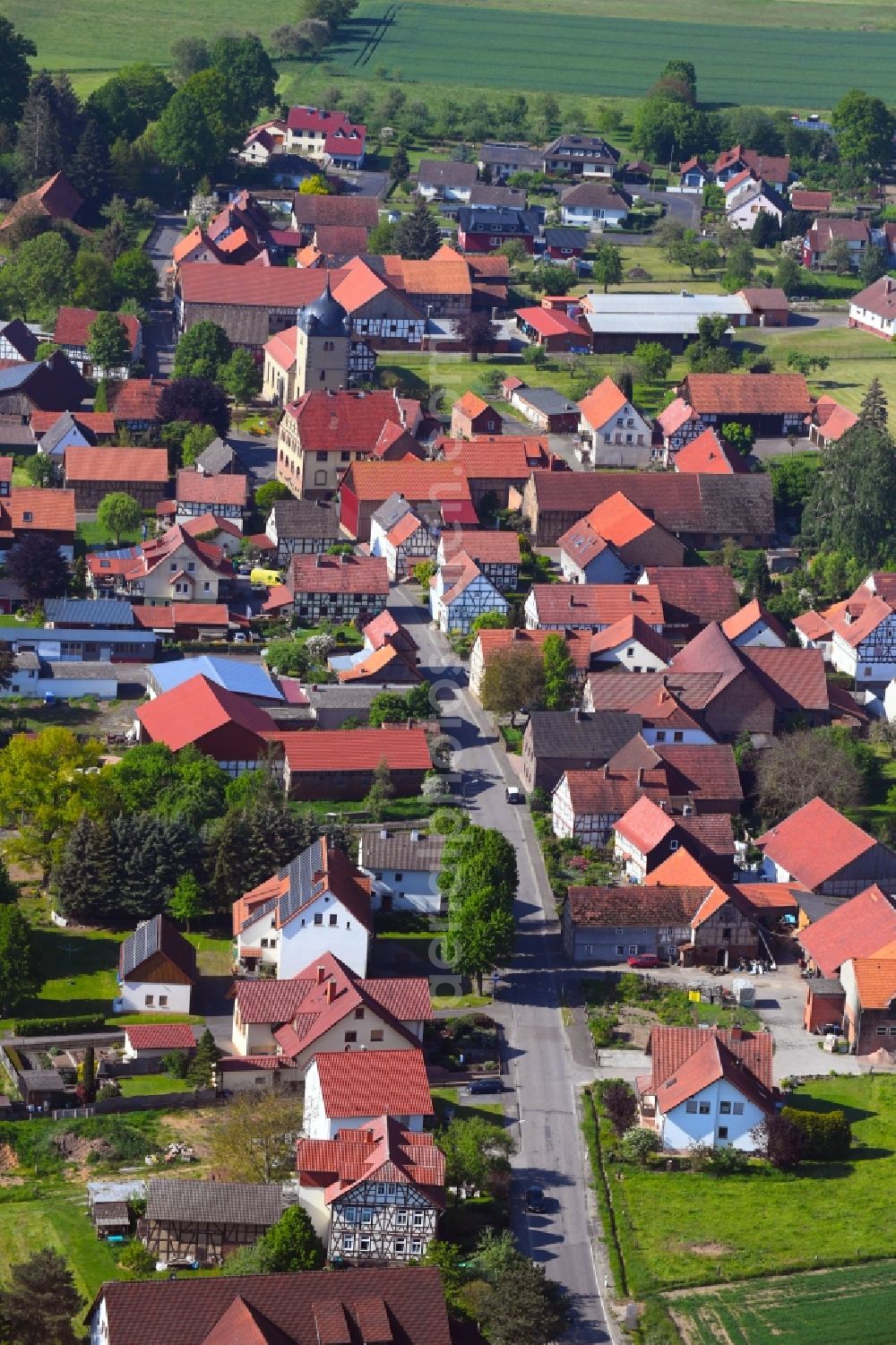 Wehrda from the bird's eye view: Village view on the edge of agricultural fields and land in Wehrda in the state Hesse, Germany