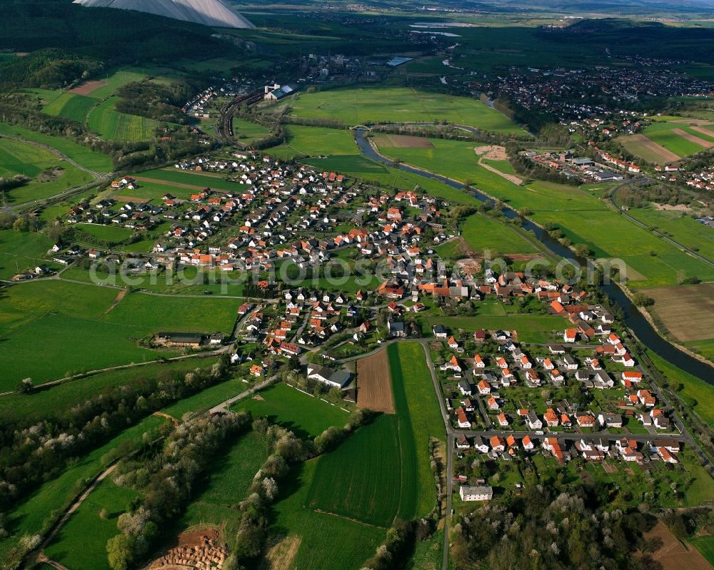 Wölfershausen from the bird's eye view: Village view on the edge of agricultural fields and land in Wölfershausen in the state Hesse, Germany