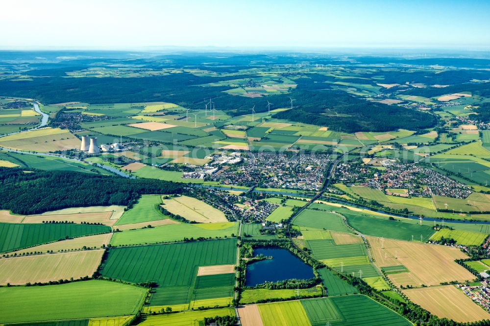 Aerial image Emmerthal - View of the town and reactor blocks, cooling tower structures of the Nuclear Power Plant Grohnde on the Weser in the evening glow in Grohnde in the state Lower Saxony, Germany