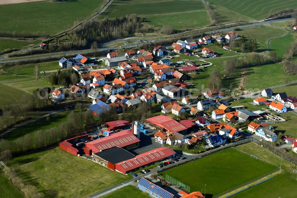 Brand from above - Town view of the streets, houses of the residential areas and the industrial area in Brand in the Rhoen in the state Hesse, Germany