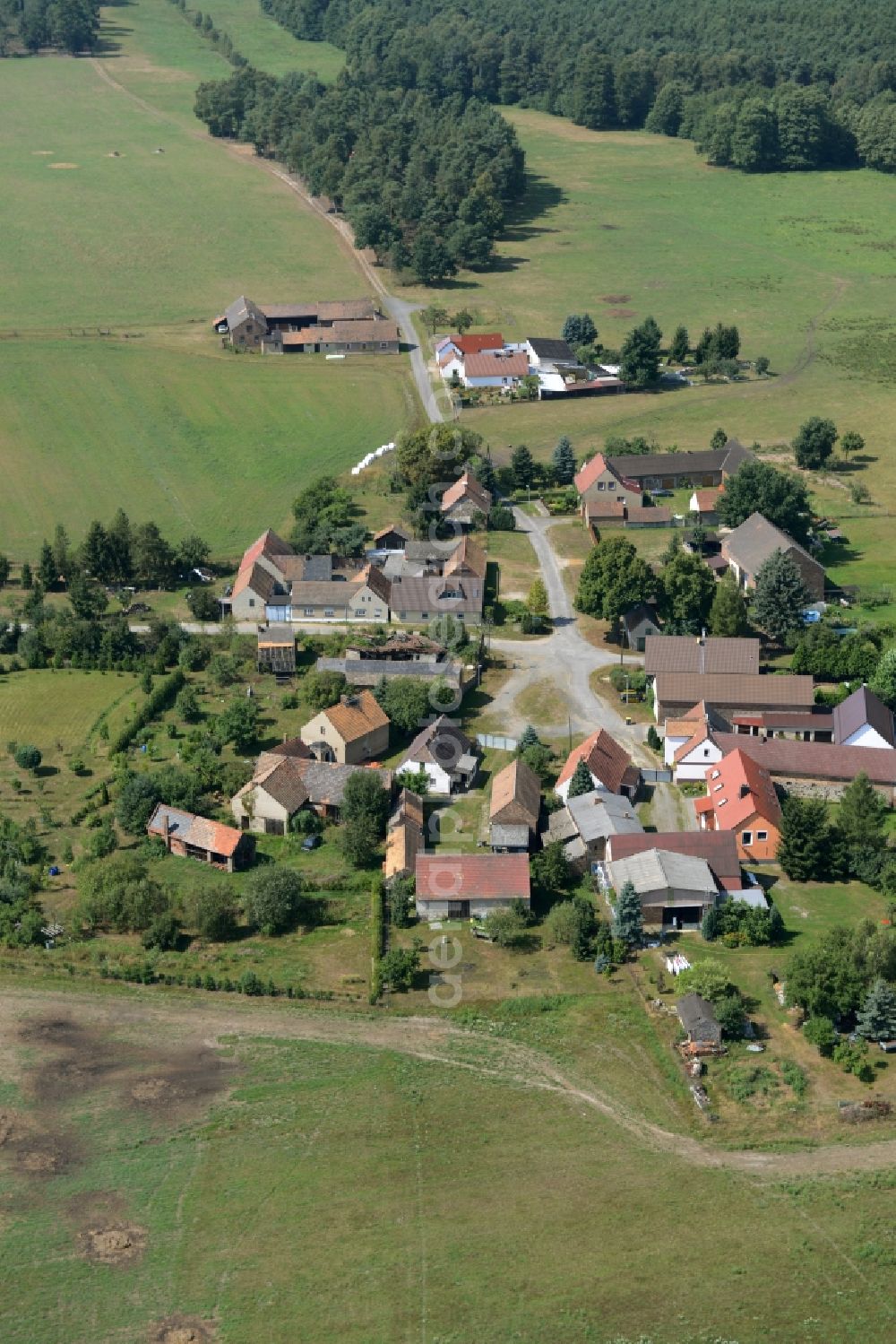 Calau from the bird's eye view: View of the village of Schrakau in the state of Brandenburg. The residential village is located in the forest area of the nature park of Niederlausitzer Landruecken