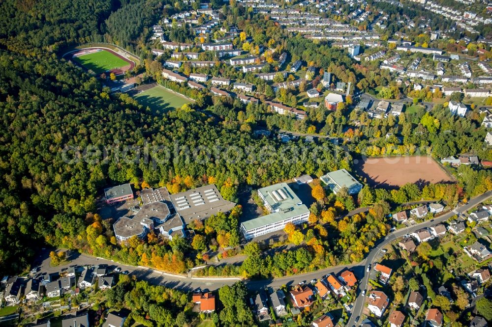 Aerial photograph Siegen - Town View of the streets and houses of the residential areas in Siegen in the state North Rhine-Westphalia. You can see the secondary school Am Schiessberg, the Geschwister-Scholl-school and the Hofbachstadion